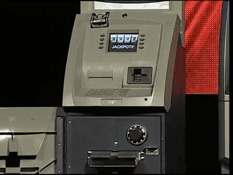 an animated GIF of an ATM dispensing wads of cash on stage at the Black Hat conference in 2009.