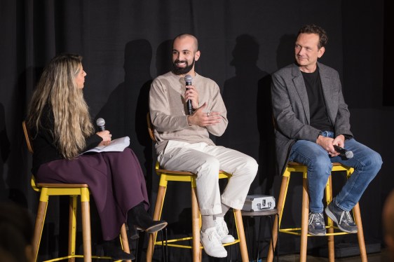 stage panel with Marina Temkin and Mina Fahmi . Two men and a techcrunch reporter on stage at a StrictlyVc event