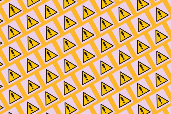 yellow warning symbols with exclamation points on a patterned background