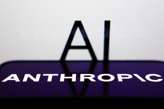 AI sign displayed on a screen and Anthropic logo displayed on a phone screen are seen in this illustration photo.
