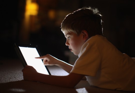 A young boy using an Apple iPad