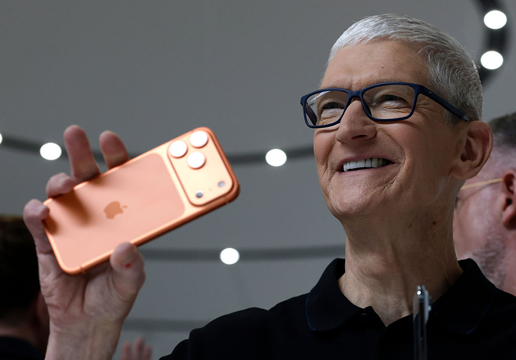 Apple CEO Tim Cook holds up a new iPhone 17 Pro