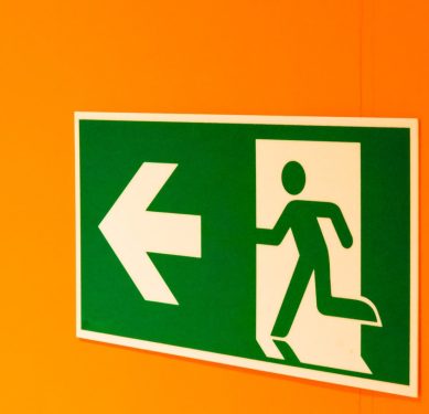 emergency exit sign on an orange wall